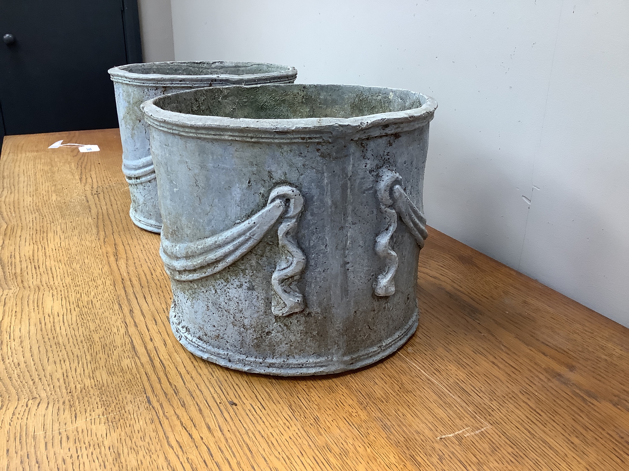 A pair of circular lead garden planters, 23cm diameter, height 20cm